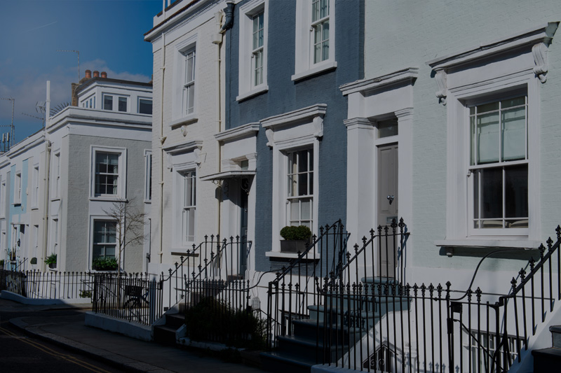 A row of refurbished period townhouses with fresh white render